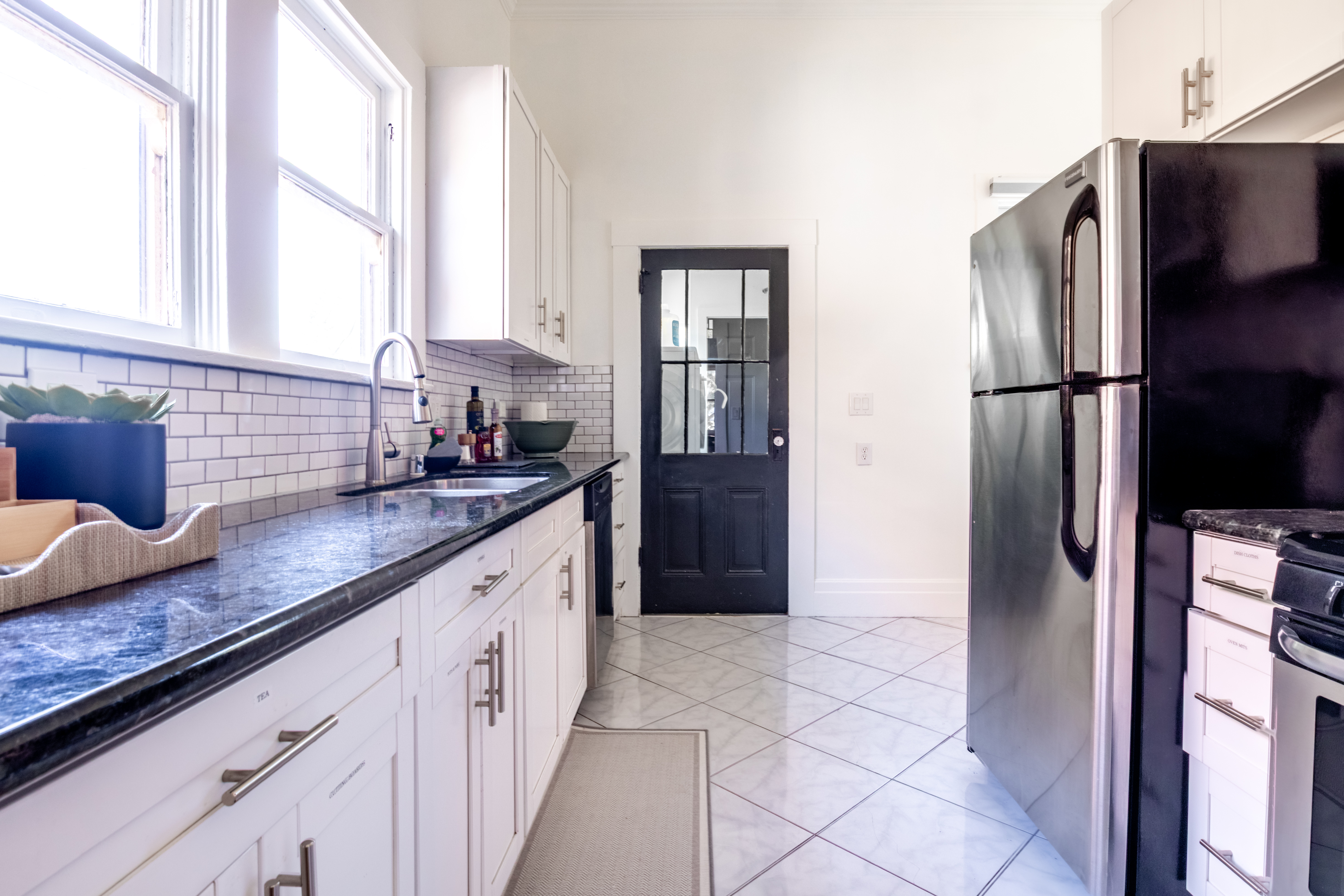 Kitchen with white cabinets and subway tile backsplash