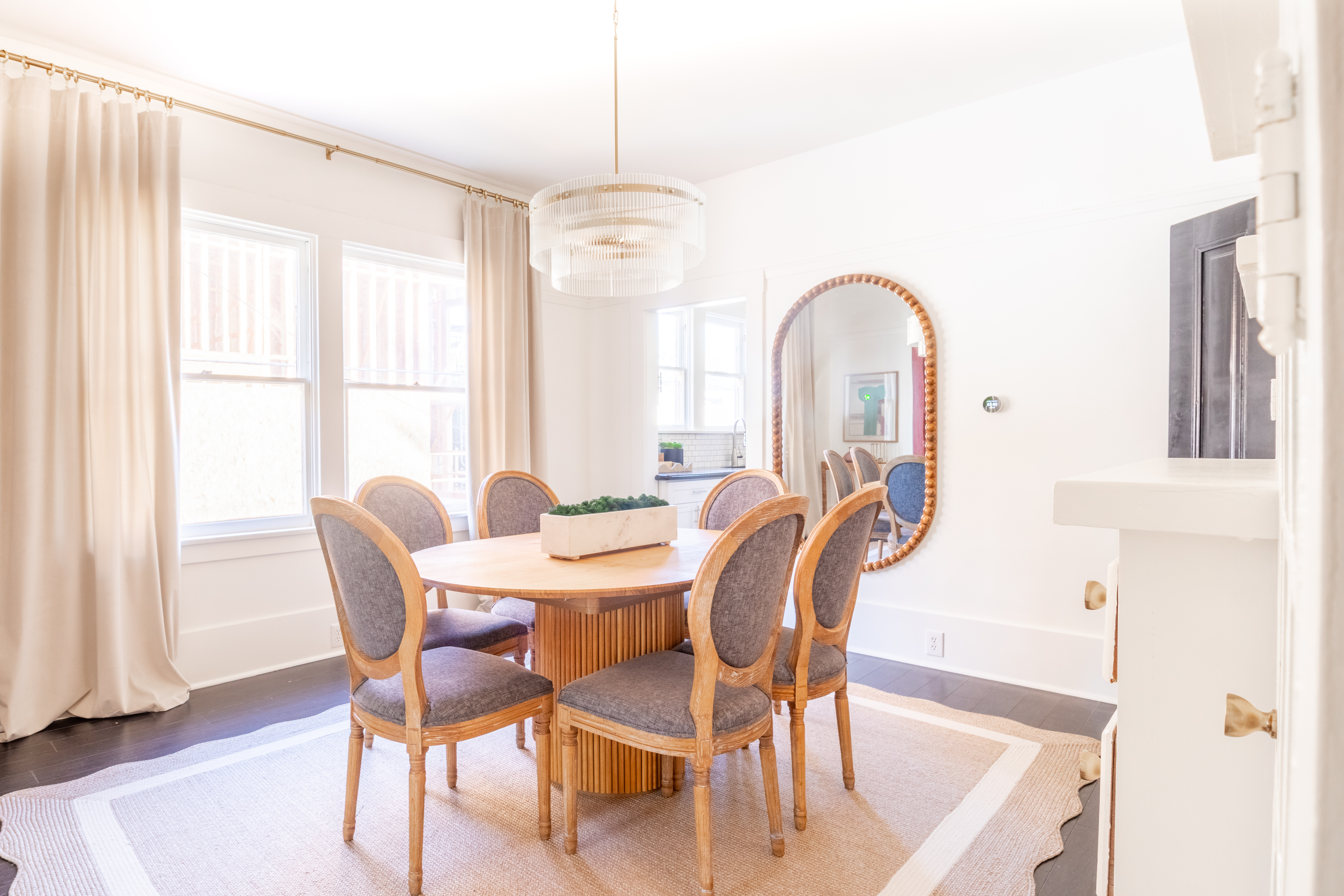 Dining room from alternate angle with arched mirror