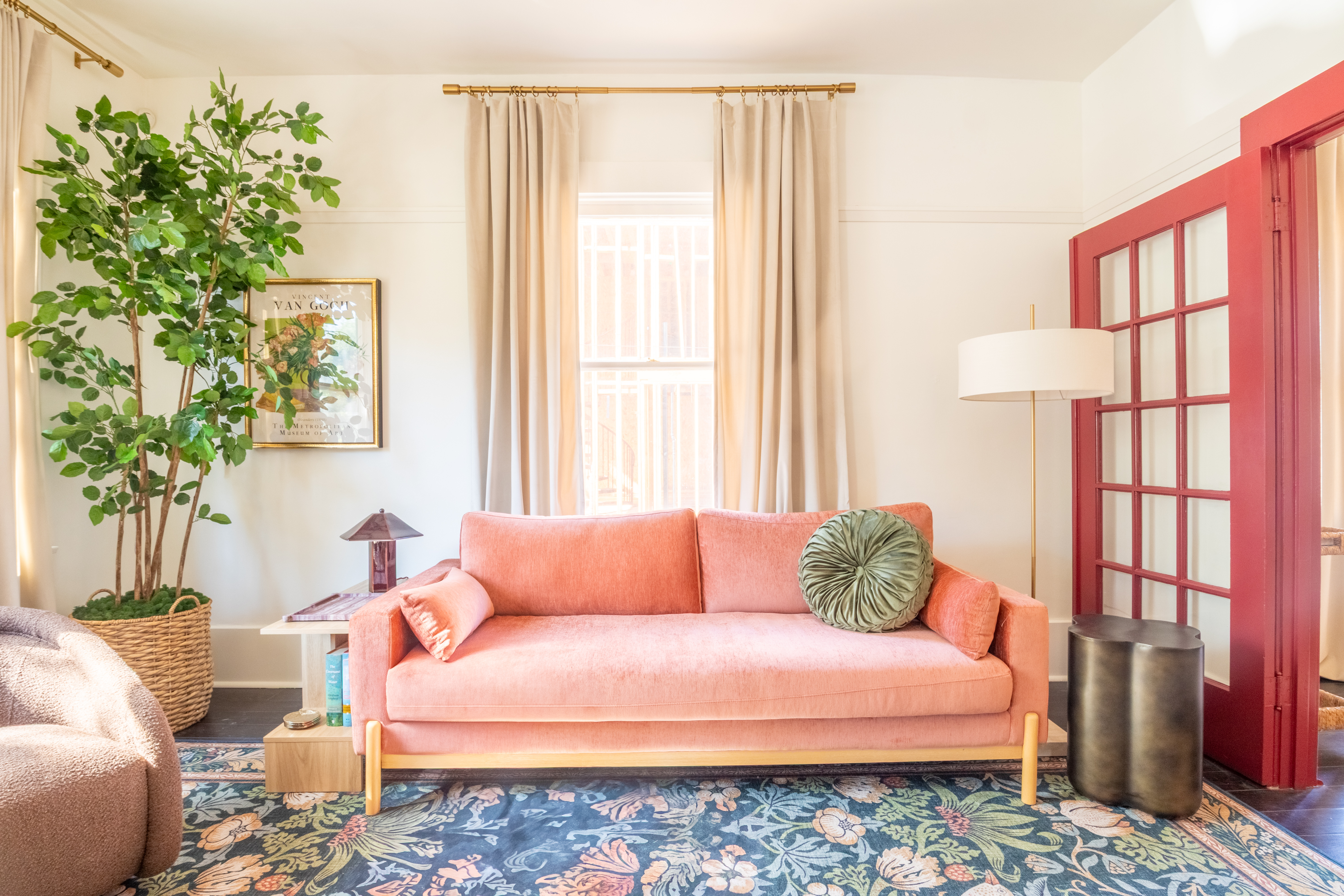Living room parlor with pink sofa and tall windows